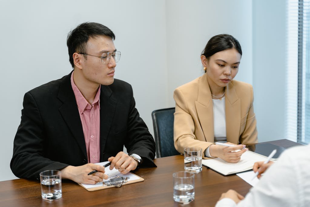 Diverse professionals engaged in a corporate meeting with focus on teamwork and collaboration.